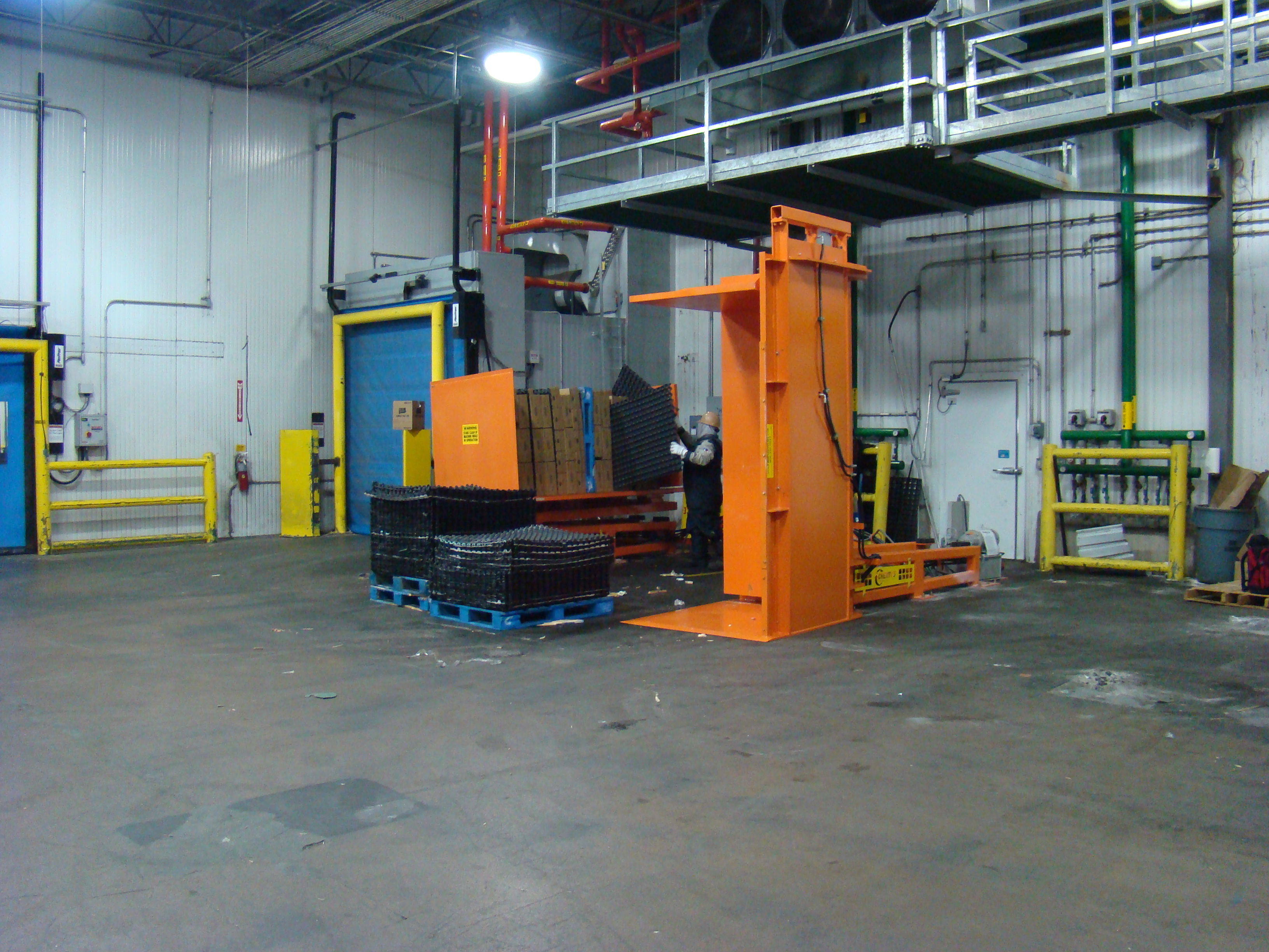 Pallet Spacer Recovery System with operator removing freezer spacers